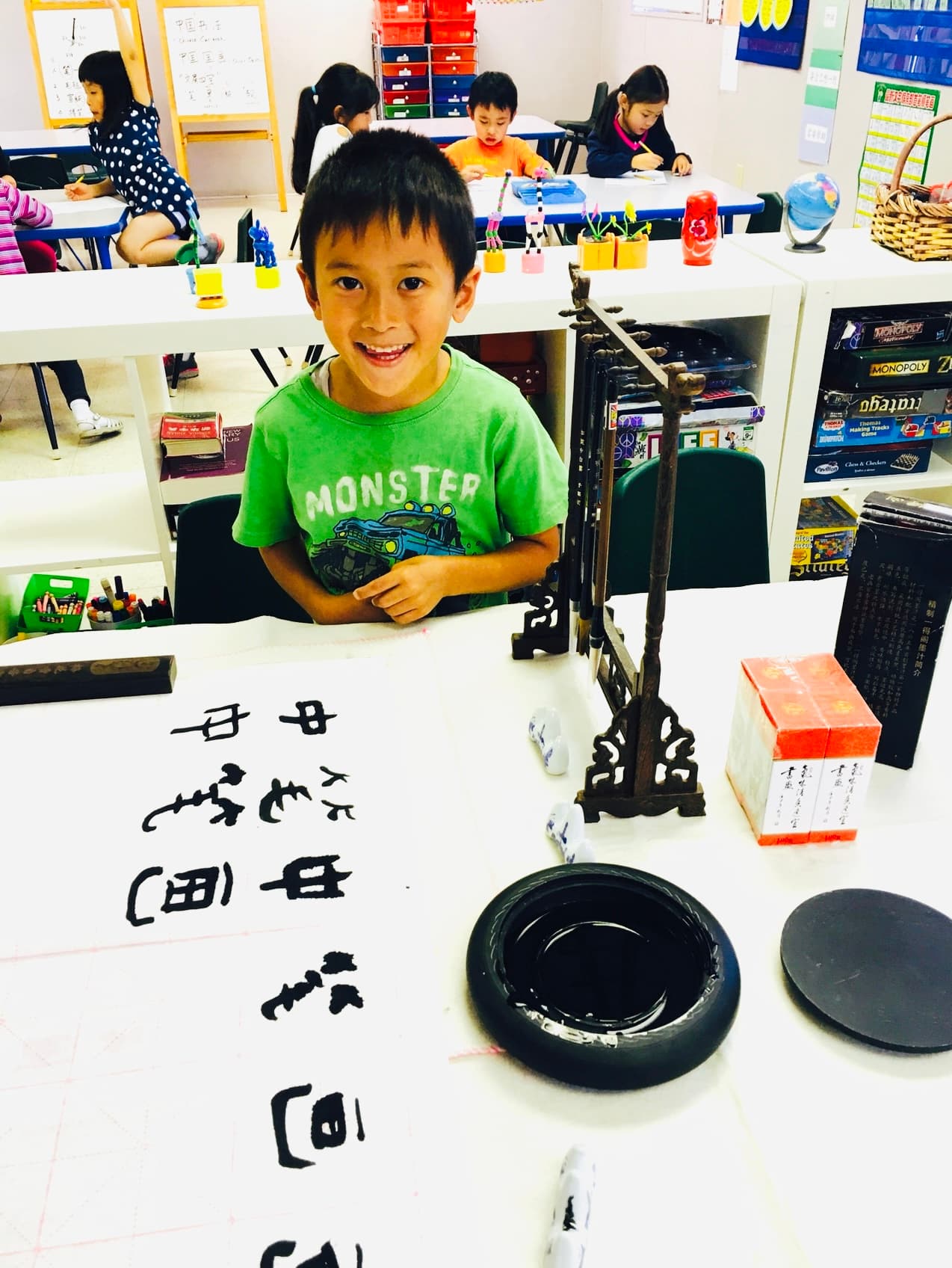 A student practices Chinese calligraphy with brush and ink.